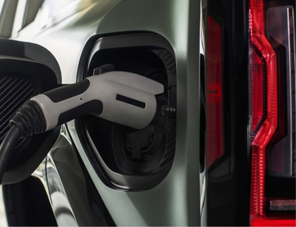 Close up of charging port with charger plugged in on a GMC Hummer EV SUV - Tinney GMC in LYNCHBURG VA